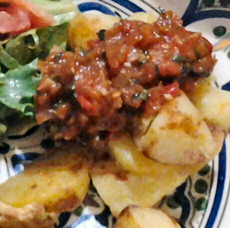 Overly delicious and simple tomato sauce recipe served over baked potatoes